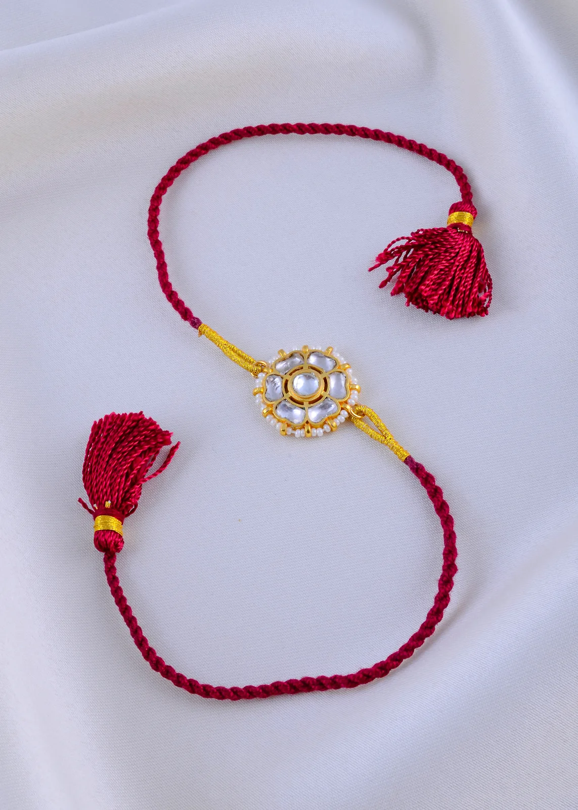 Kundan-Kiran-Red-Thread-Rakhi-Yellow-Gold-RAK001946a Kundan Kiran Red Thread Rakhi (Yellow Gold) RAK001946 - Image 1