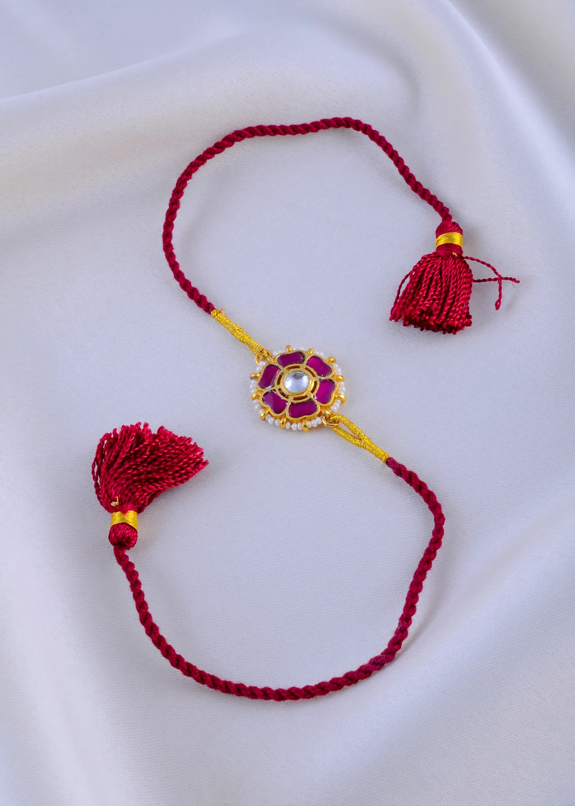 Kundan-Kiran-Ruby-Red-Thread-Rakhi-Yellow-Gold-RAK001944a Kundan Kiran Ruby Red Thread Rakhi (Yellow Gold) RAK001944 - Image 1